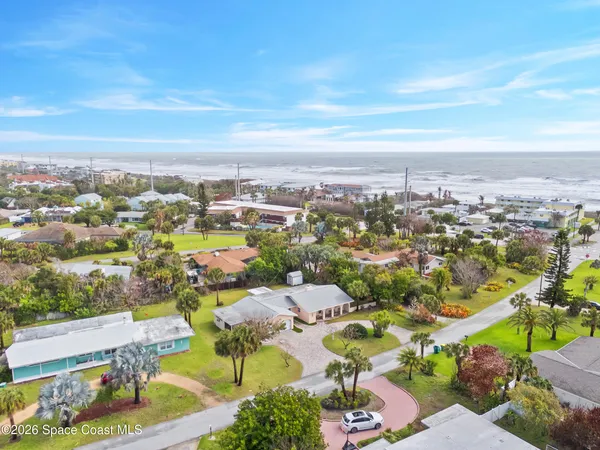 an aerial view of residential houses with outdoor space
