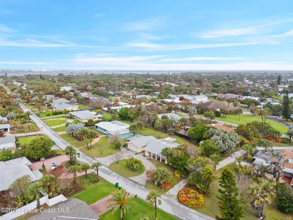 an aerial view of residential building with green space