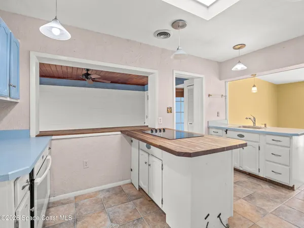 a utility room with granite countertop cabinets a washer and dryer