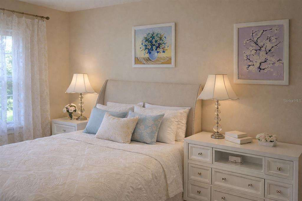 3637 Downfield Place, Unit 402 New Port Richey, FL 34655 - Photo 20 of 39 a bedroom with a bed and a lamp on dresser