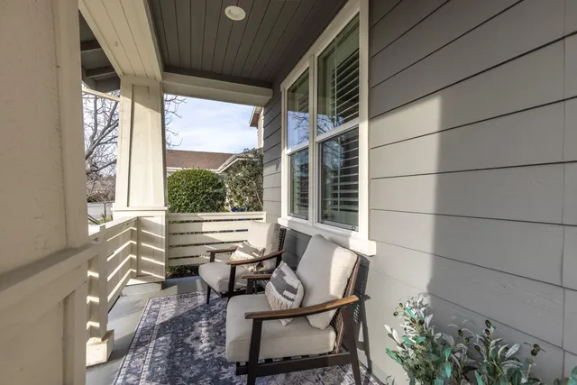 a view of a house with backyard sitting area and garden
