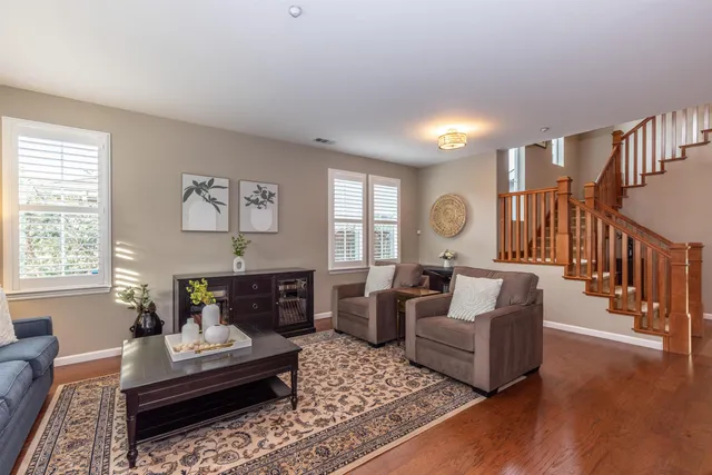 a living room with furniture and a chandelier