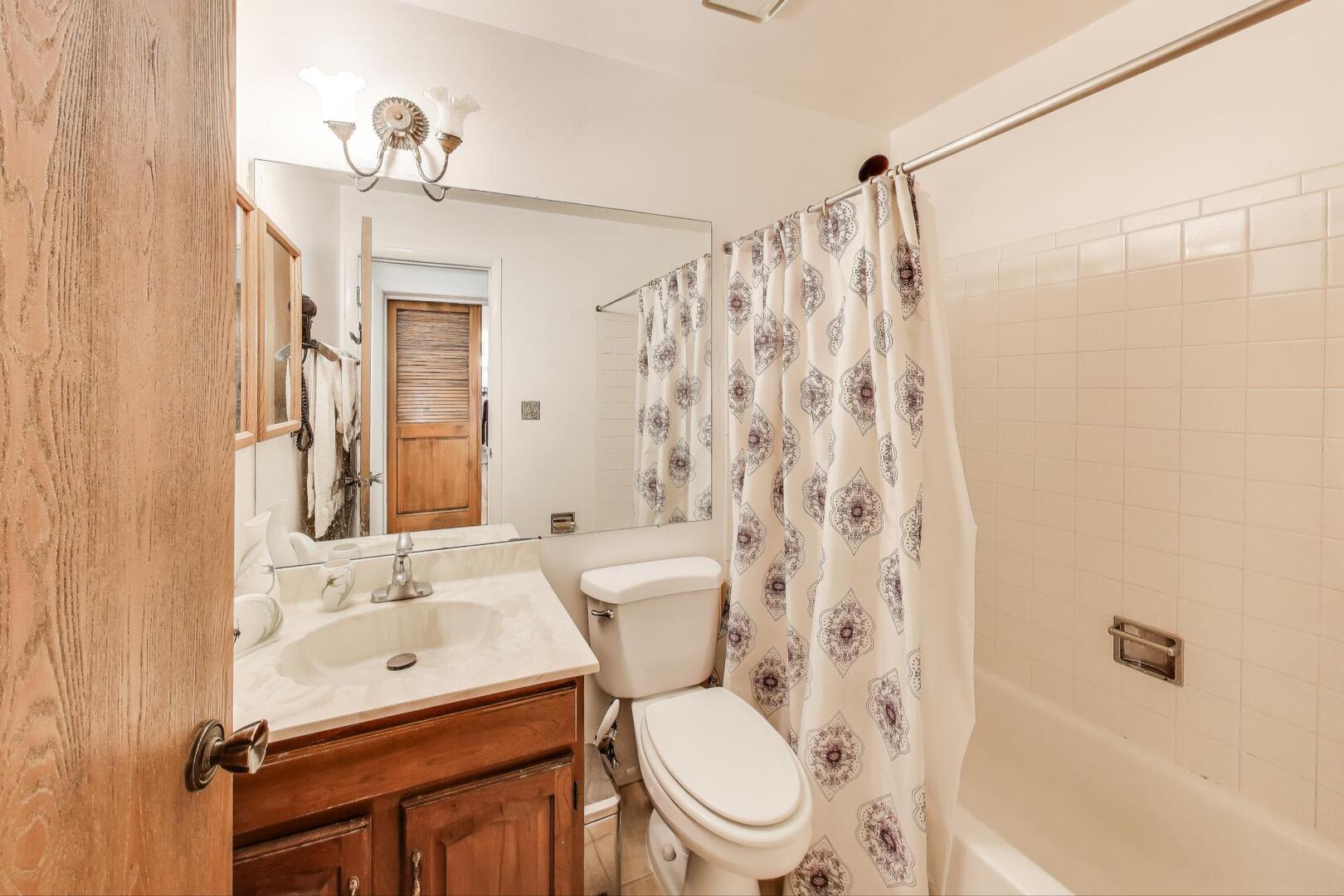 350 Newgate Court, Unit 2Z Schaumburg, IL 60193 - Photo 15 of 18 a bathroom with a sink toilet mirror and shower