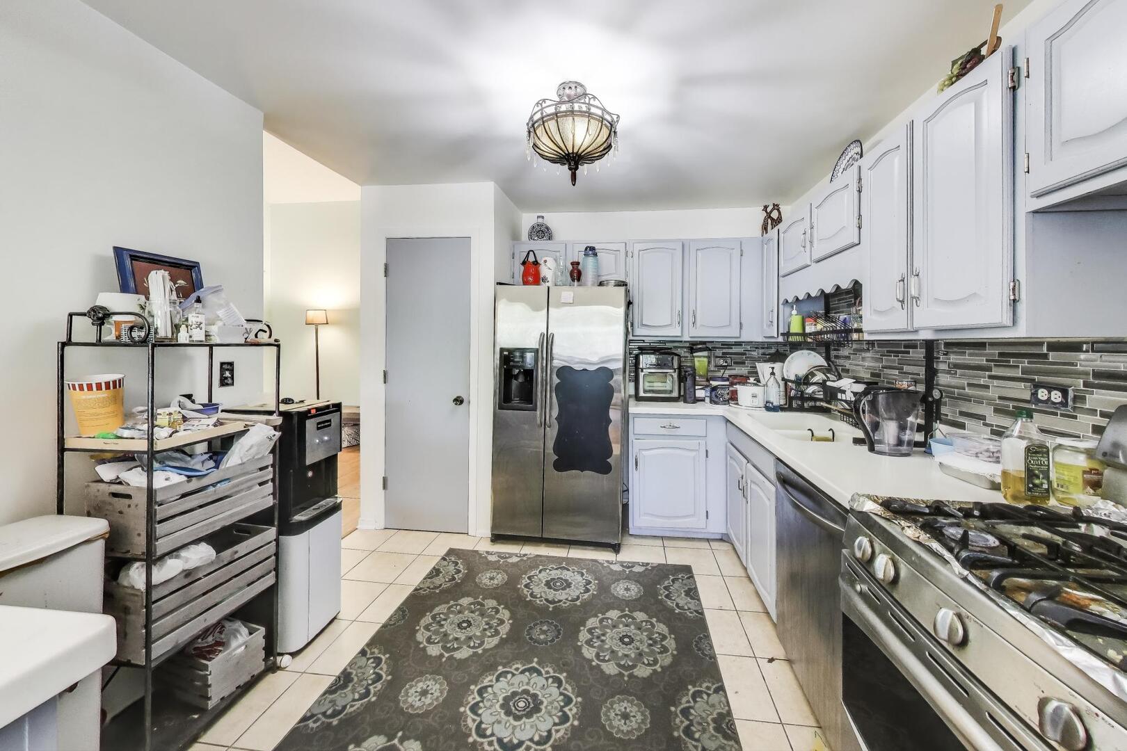 350 Newgate Court, Unit 2Z Schaumburg, IL 60193 - Photo 7 of 18 a kitchen with stainless steel appliances granite countertop a refrigerator and a stove top oven