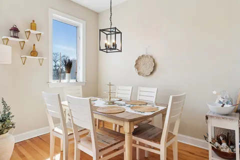 a dining room with wooden floor and breakfast area