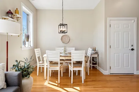 a view of a dining room with furniture wooden floor and a chandelier