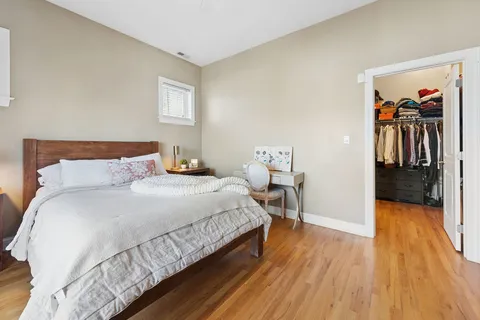 a bedroom with a bed and a view of kitchen