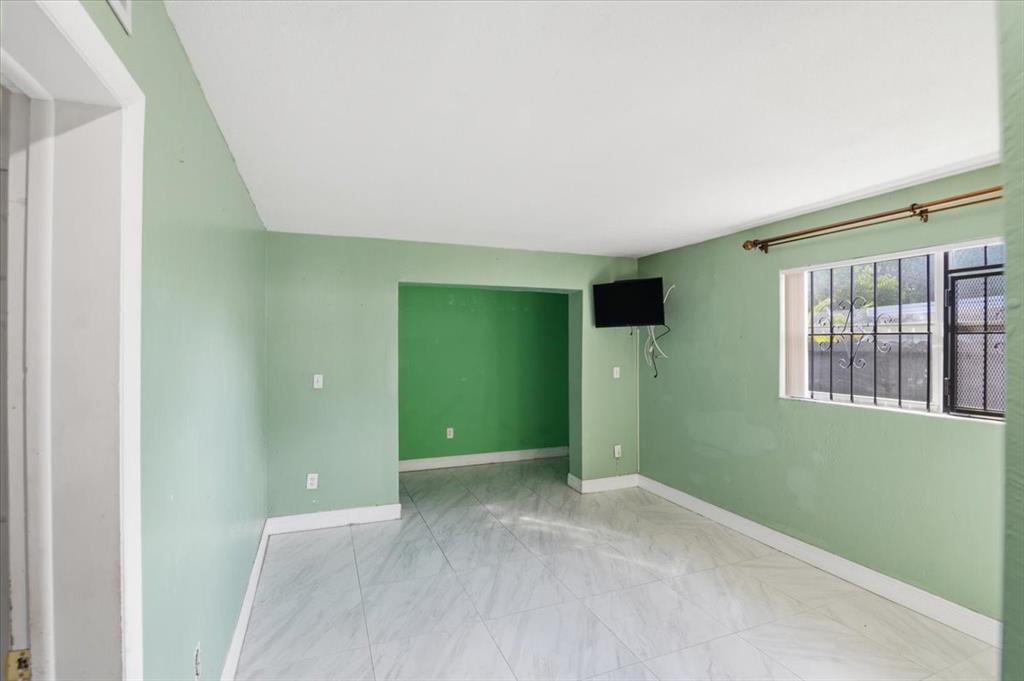 1320 Northwest 86th Street Miami, FL 33147 - Photo 17 of 41 an empty room with windows and closet