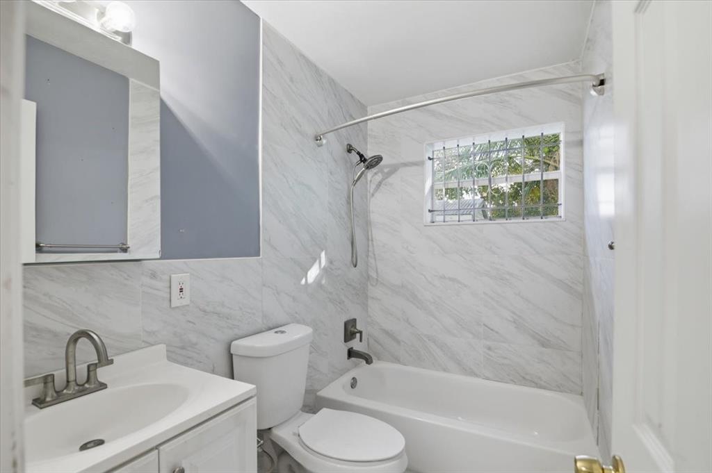 1320 Northwest 86th Street Miami, FL 33147 - Photo 23 of 41 a bathroom with a sink toilet and shower