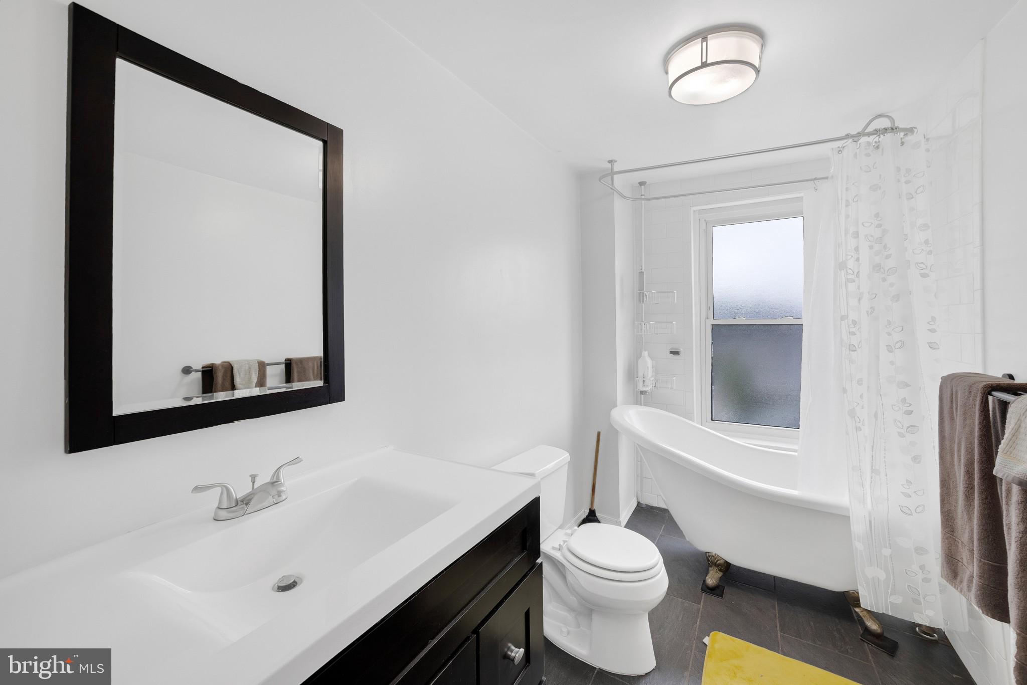 337 Lemonte Street Philadelphia, PA 19128 - Photo 12 of 18 a bathroom with a sink a toilet and mirror
