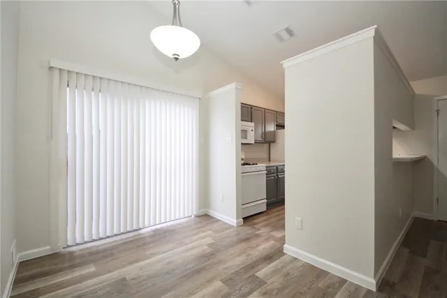 a view of a room with wooden floor