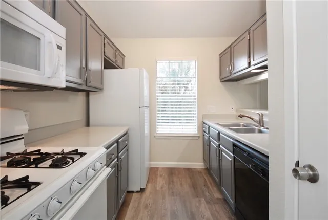 a kitchen with stainless steel appliances granite countertop a stove and a sink