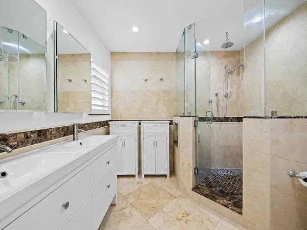 a bathroom with a double vanity sink and a mirror