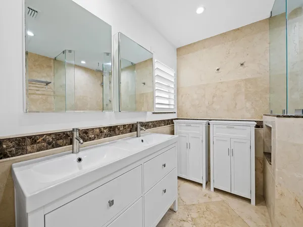 a bathroom with a sink and mirror