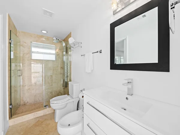 a bathroom with a toilet sink and shower
