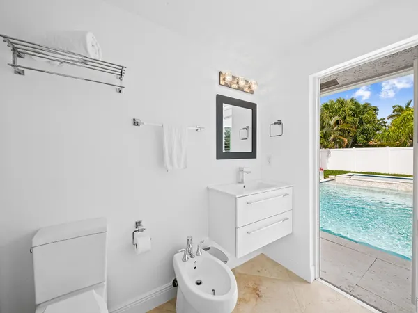 a bathroom with a toilet a sink and mirror