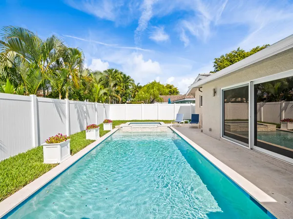 a view of swimming pool with a garden and deck