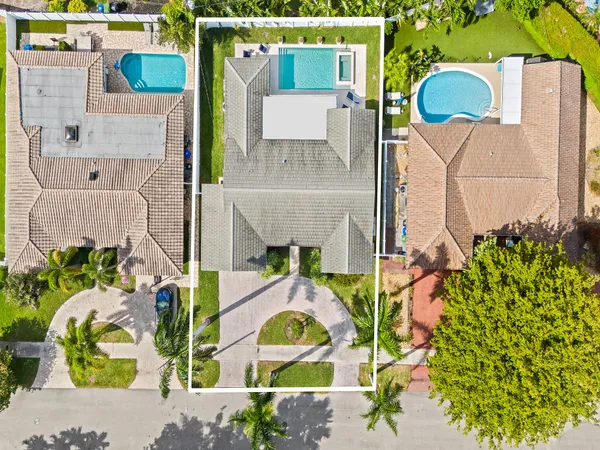 an aerial view of a house with a swimming pool