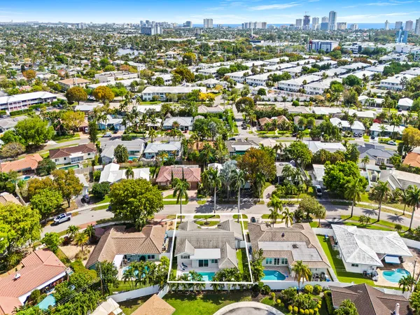 an aerial view of residential houses with city view