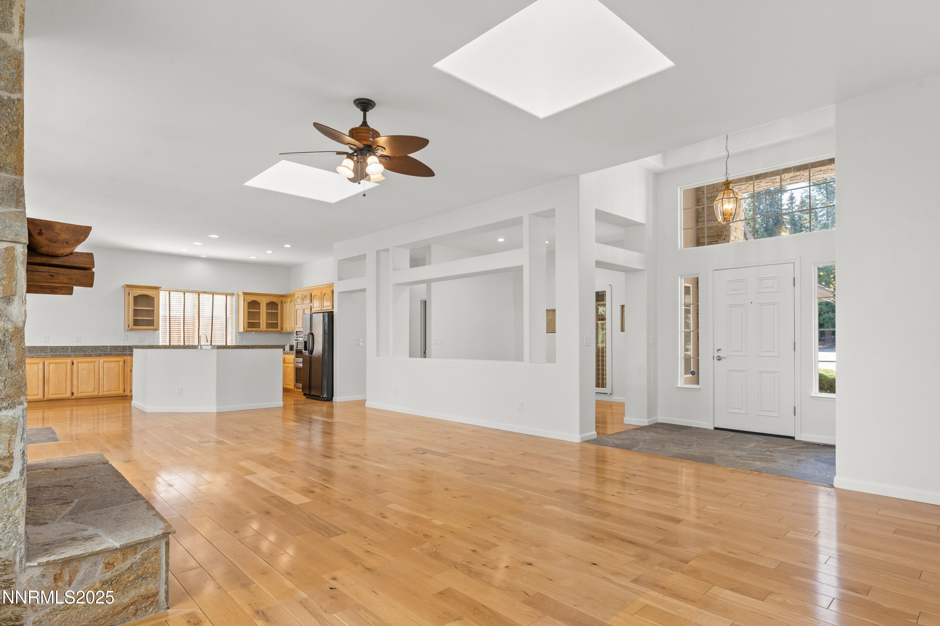 4991 West Albuquerque Road Reno, NV 89511 - Photo 11 of 60 a view of a livingroom with wooden floor and a ceiling fan