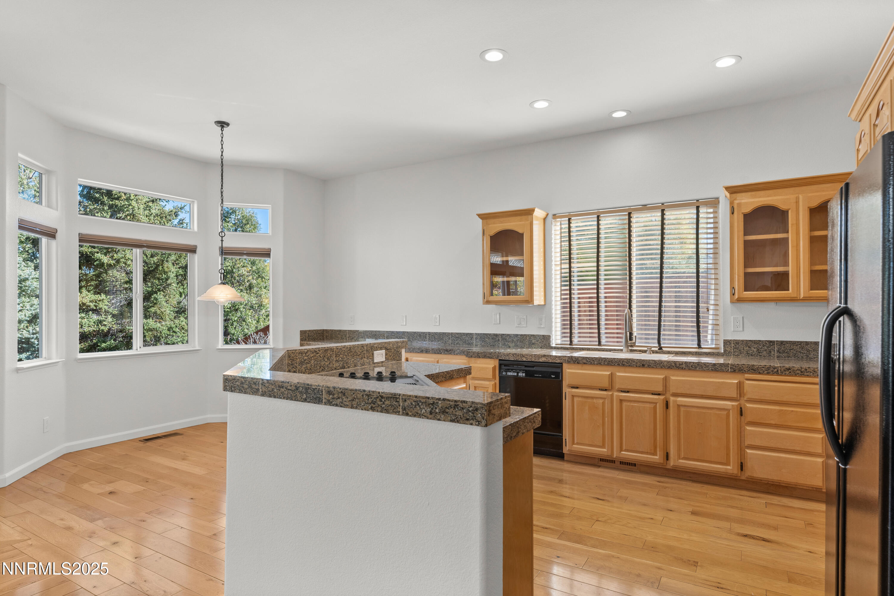 4991 West Albuquerque Road Reno, NV 89511 - Photo 14 of 60 a kitchen with stainless steel appliances granite countertop a sink stove and cabinets