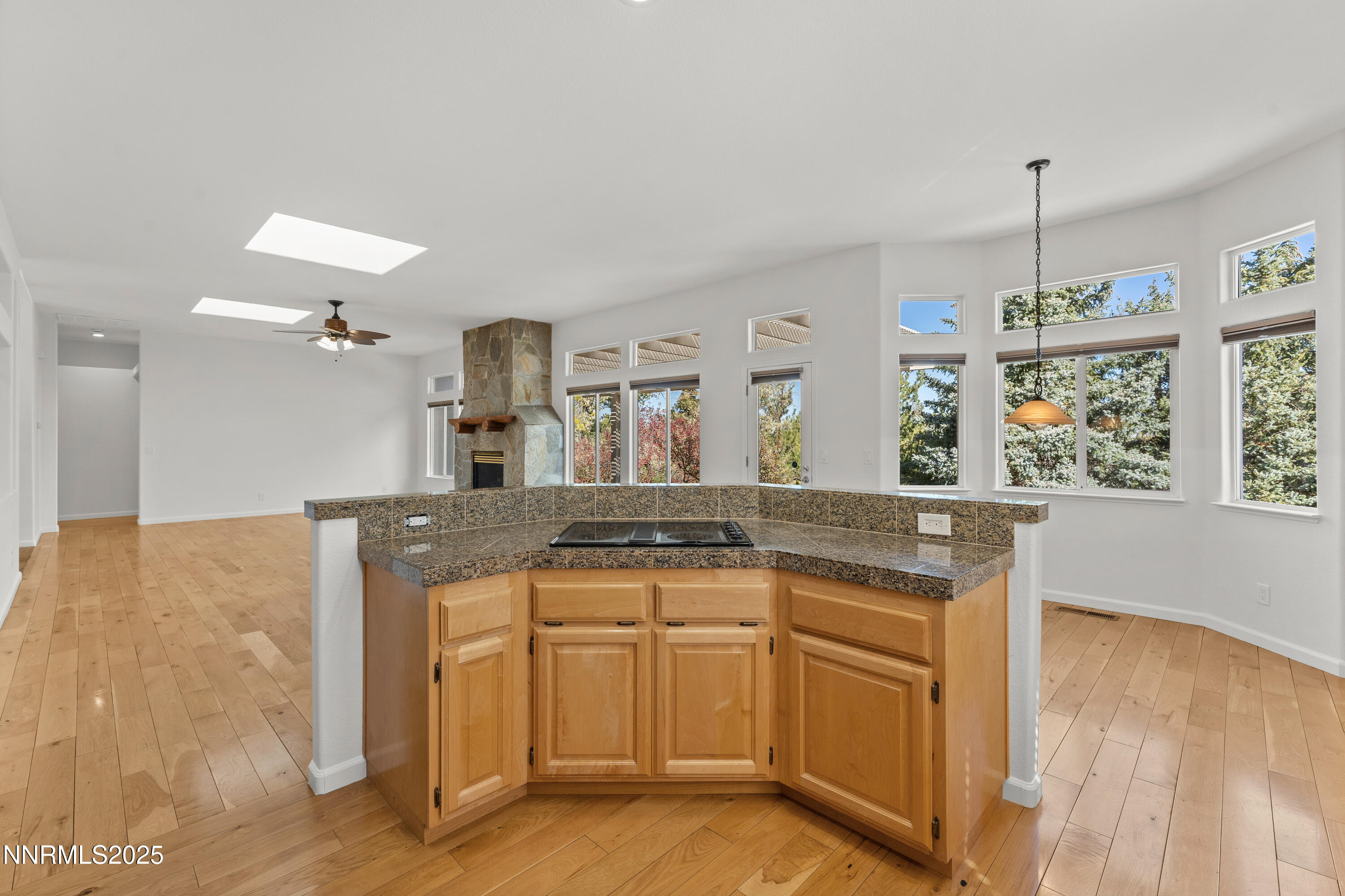 4991 West Albuquerque Road Reno, NV 89511 - Photo 15 of 60 a kitchen with granite countertop a stove a sink and a wooden floors