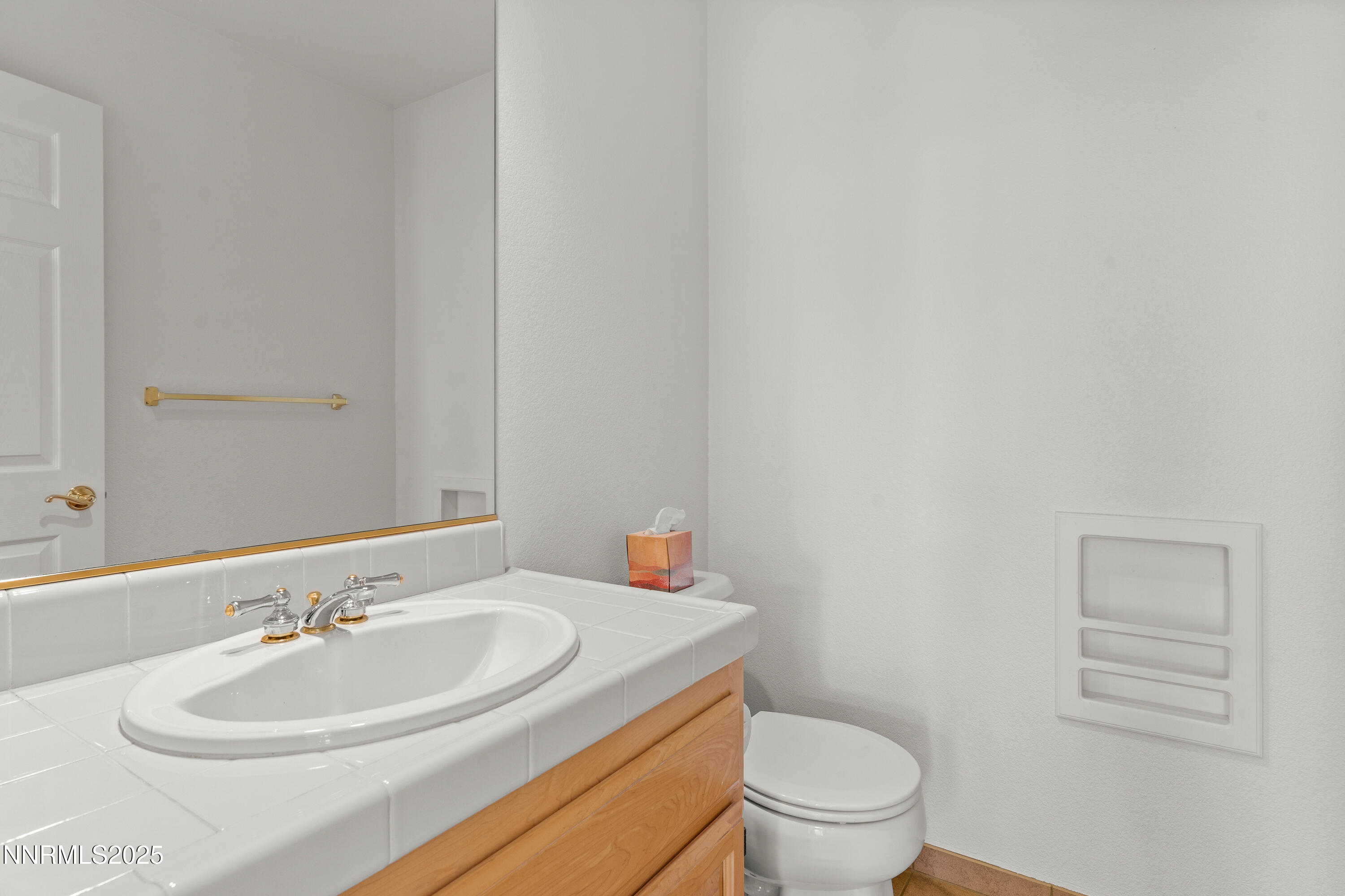 4991 West Albuquerque Road Reno, NV 89511 - Photo 36 of 60 a bathroom with a sink a toilet and a mirror