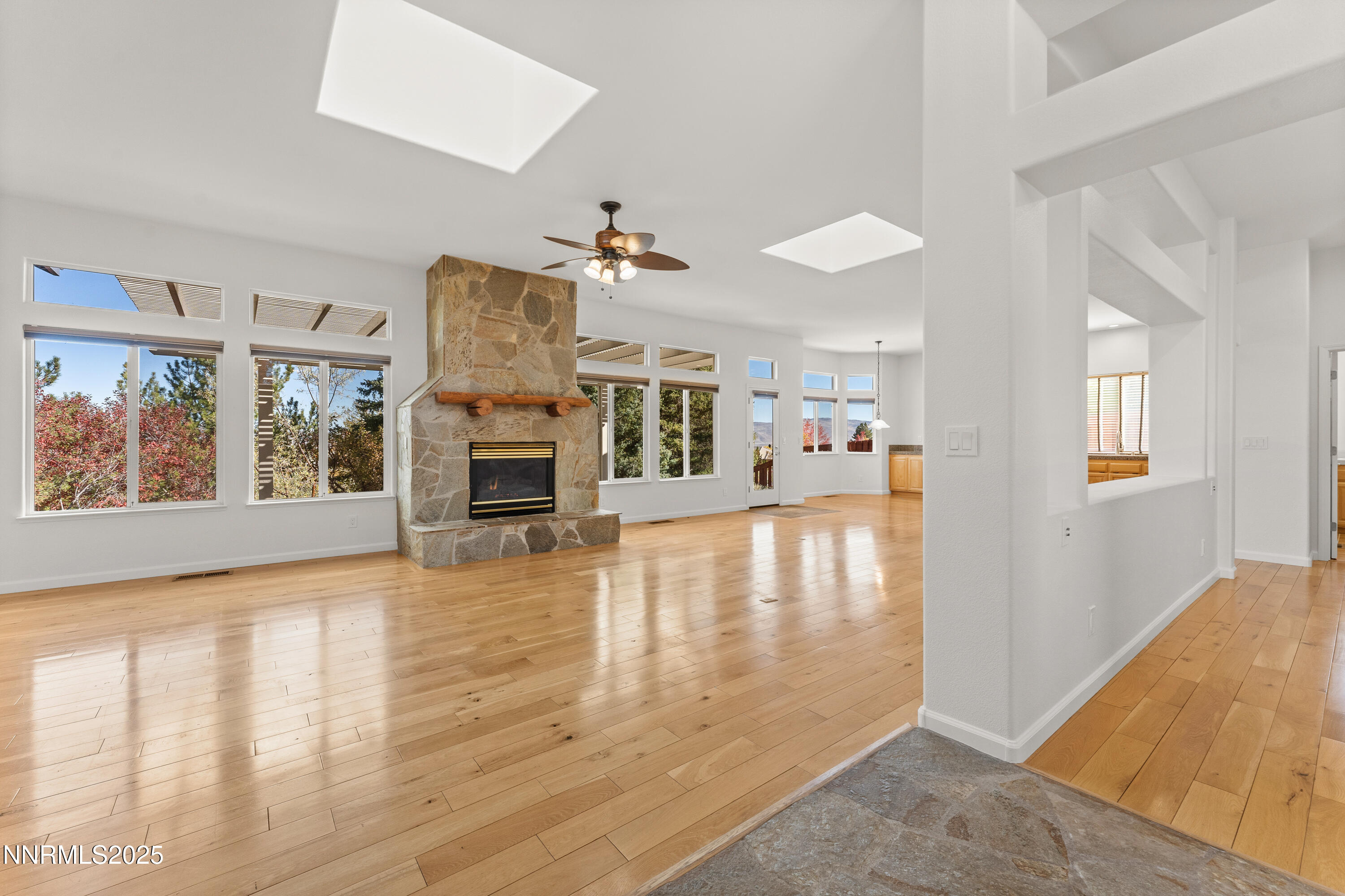 4991 West Albuquerque Road Reno, NV 89511 - Photo 4 of 60 a view of a livingroom with furniture a fireplace wooden floor and windows