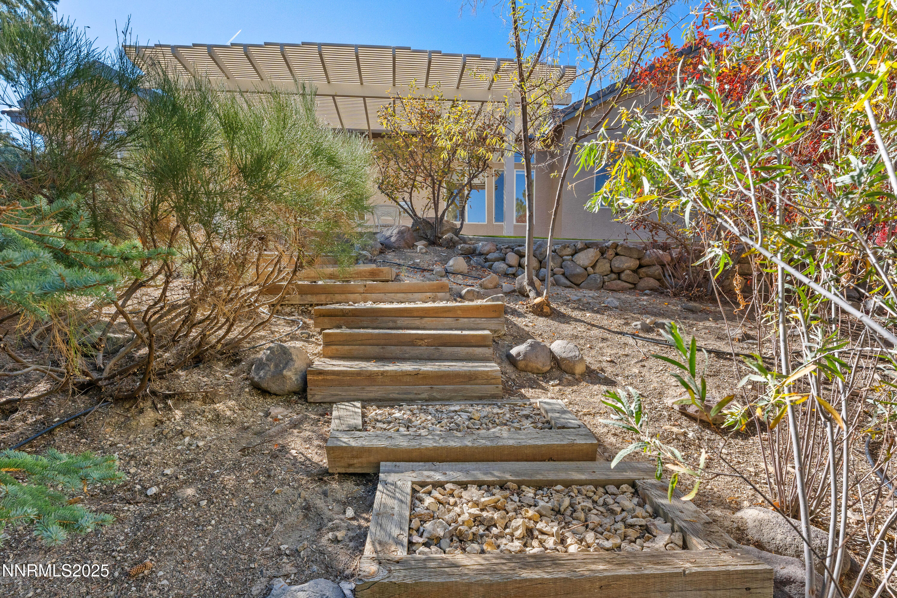 4991 West Albuquerque Road Reno, NV 89511 - Photo 46 of 60 a view of a yard with plants and large trees
