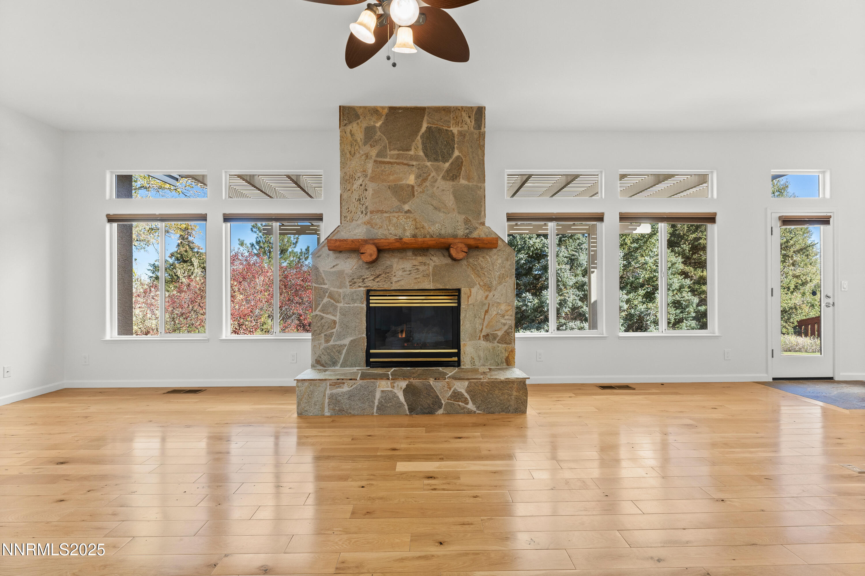 4991 West Albuquerque Road Reno, NV 89511 - Photo 7 of 60 wooden floor fireplace and windows in an empty room