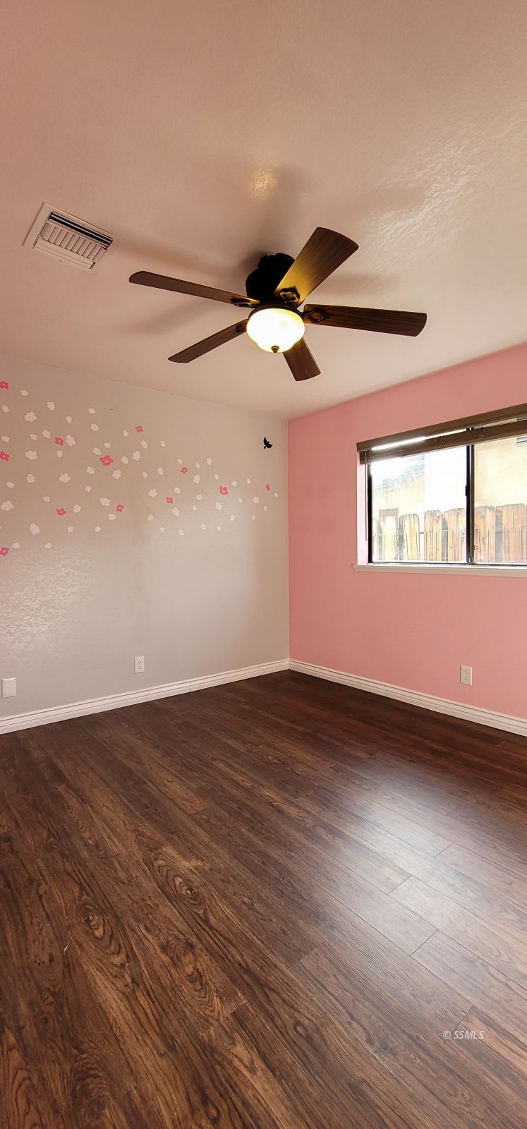 544 Weiman Avenue Ridgecrest, CA 93555 - Photo 9 of 20 a view of an empty room with wooden floor and a window