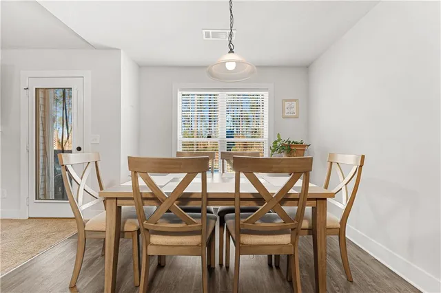 a view of a dining room with furniture and windows