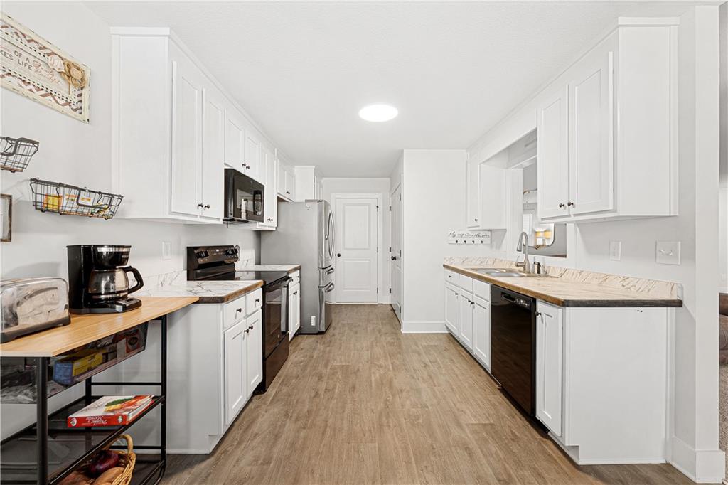 328 Walnut Drive Hartwell, GA 30643 - Photo 14 of 33 a kitchen with stainless steel appliances granite countertop a sink stove and cabinets