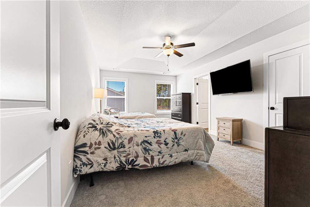 328 Walnut Drive Hartwell, GA 30643 - Photo 18 of 33 a bedroom with a bed and a flat screen tv