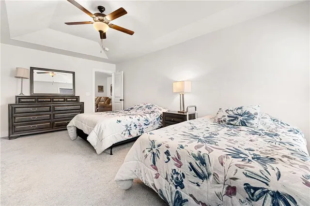 a bedroom with two beds and painting on the wall