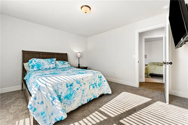 a bedroom with a bed and a television