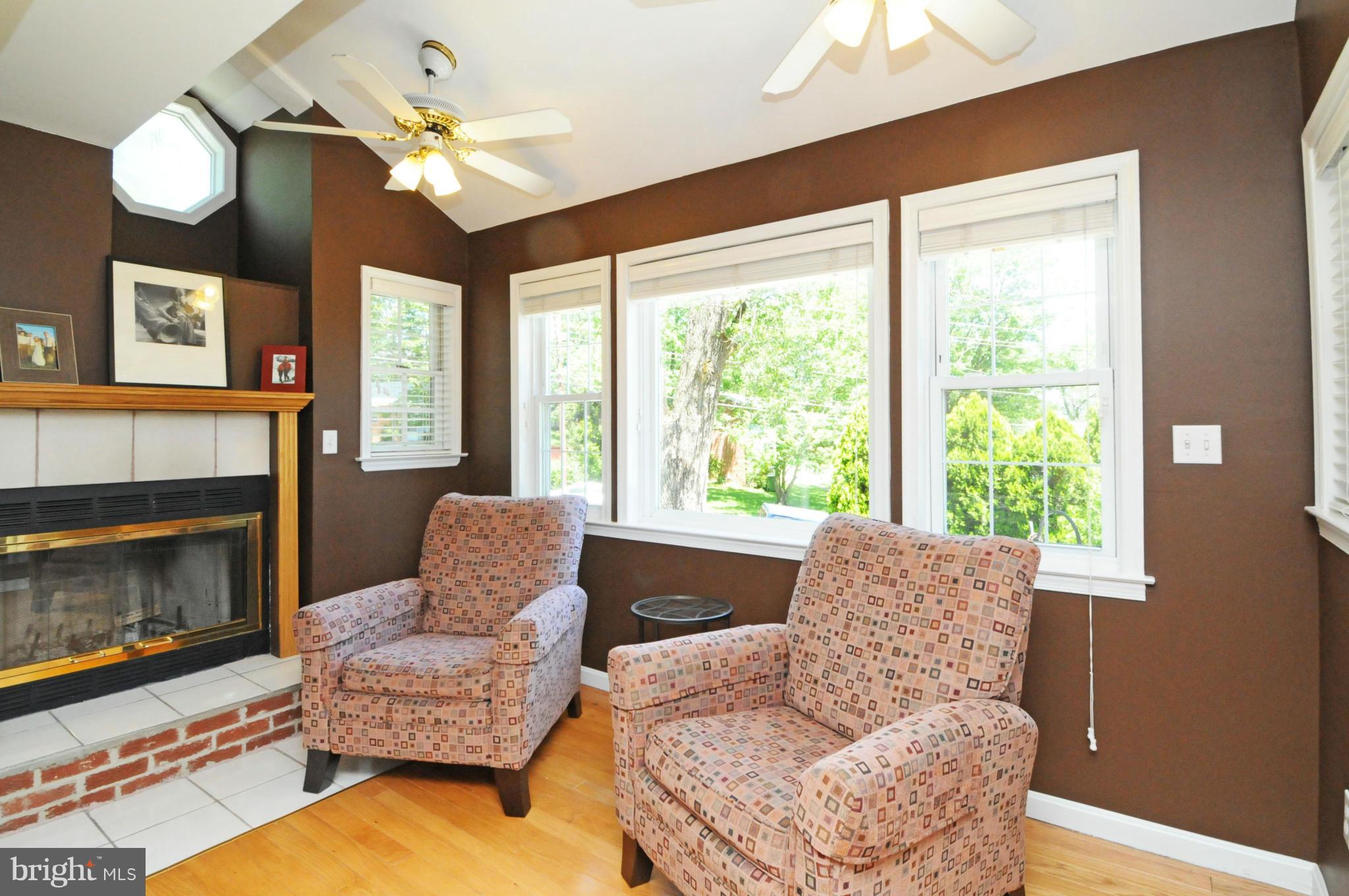 6313 Beryl Road Alexandria, VA 22312 - Photo 2 of 30 a living room with furniture chandelier and a fireplace