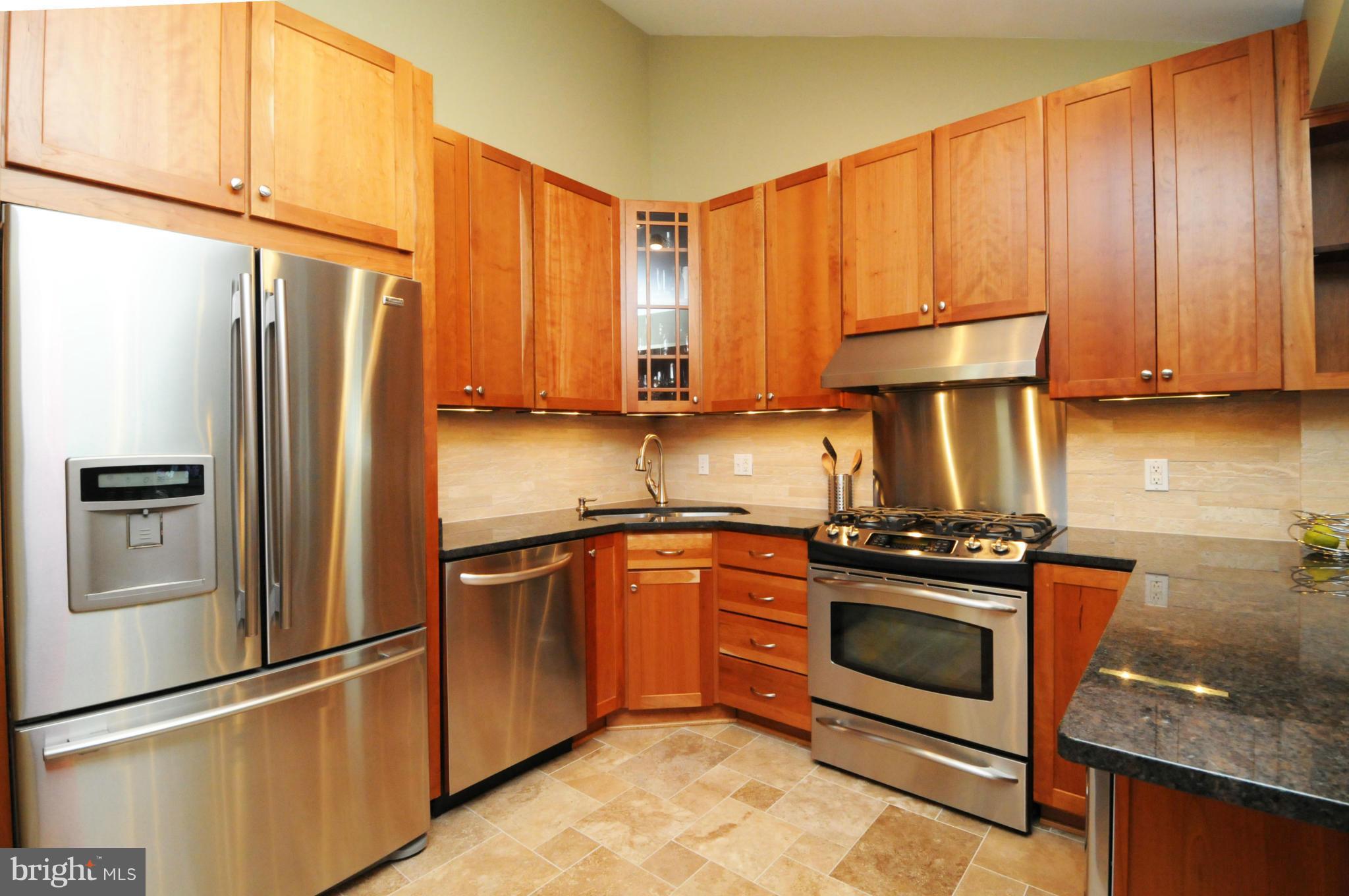 6313 Beryl Road Alexandria, VA 22312 - Photo 11 of 30 a kitchen with stainless steel appliances granite countertop a refrigerator sink and stove