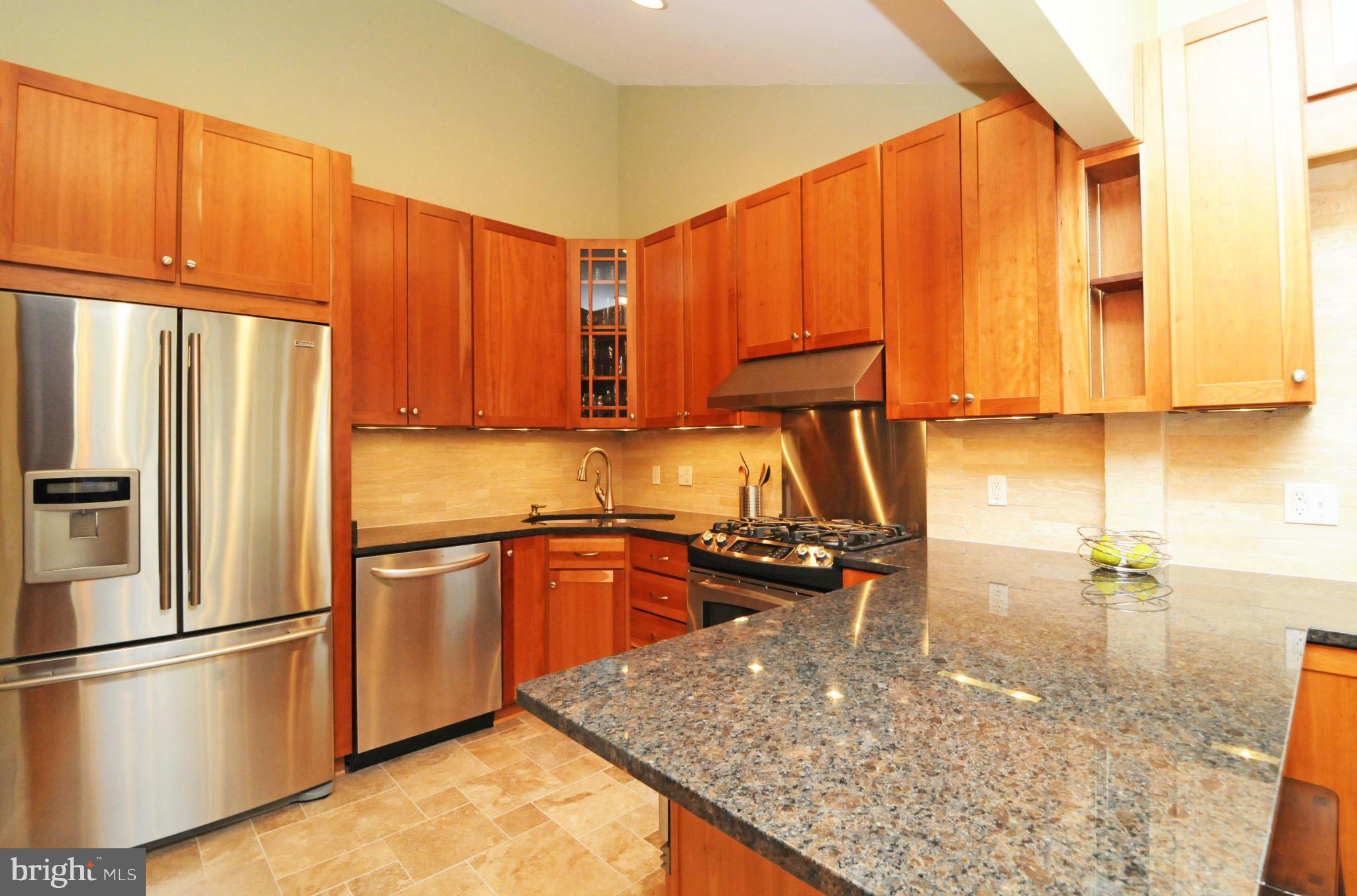 6313 Beryl Road Alexandria, VA 22312 - Photo 12 of 30 a kitchen with stainless steel appliances granite countertop a refrigerator a stove and a sink with wooden cabinets