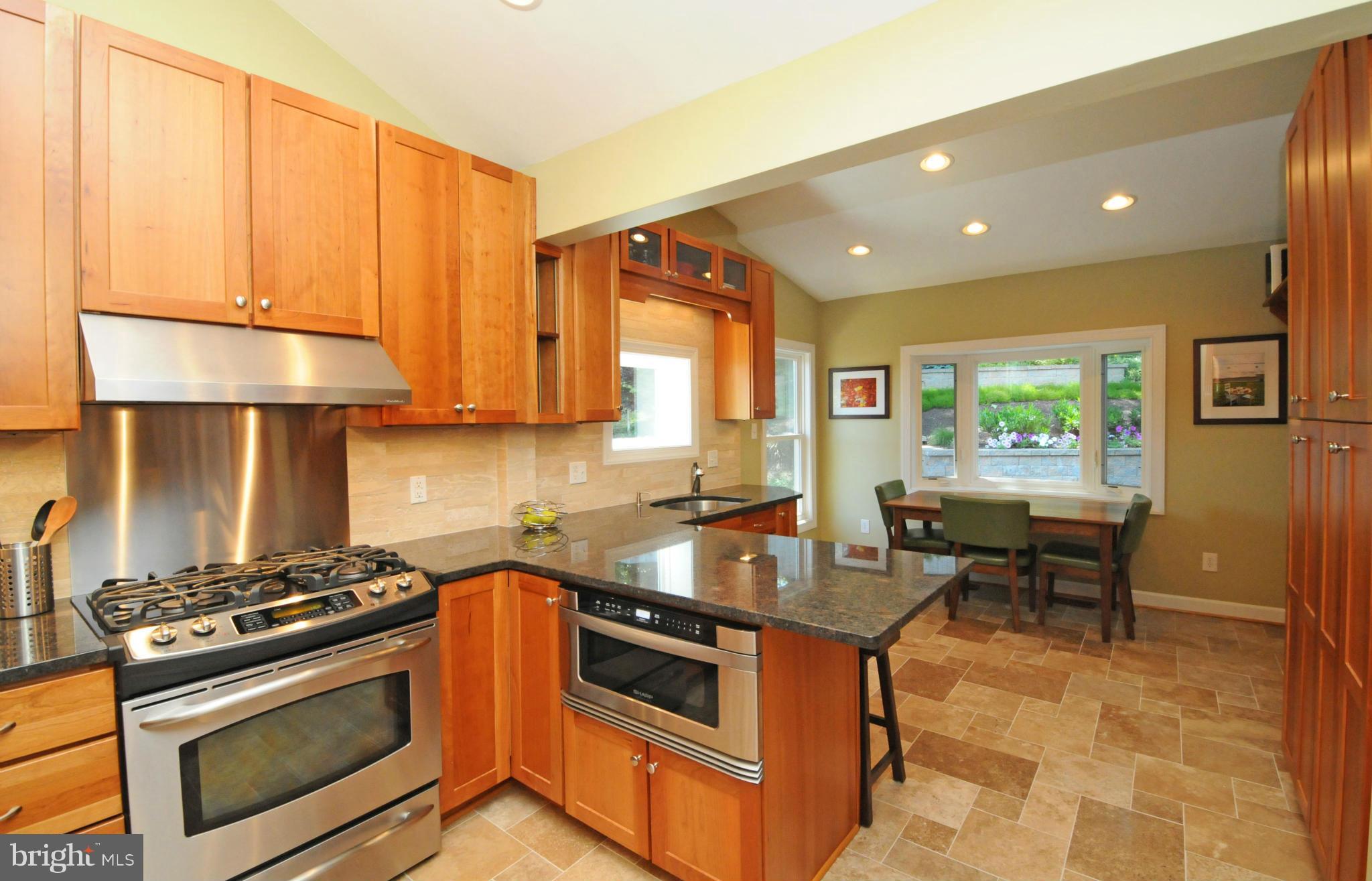 6313 Beryl Road Alexandria, VA 22312 - Photo 13 of 30 a kitchen with stainless steel appliances granite countertop a stove a sink and a microwave