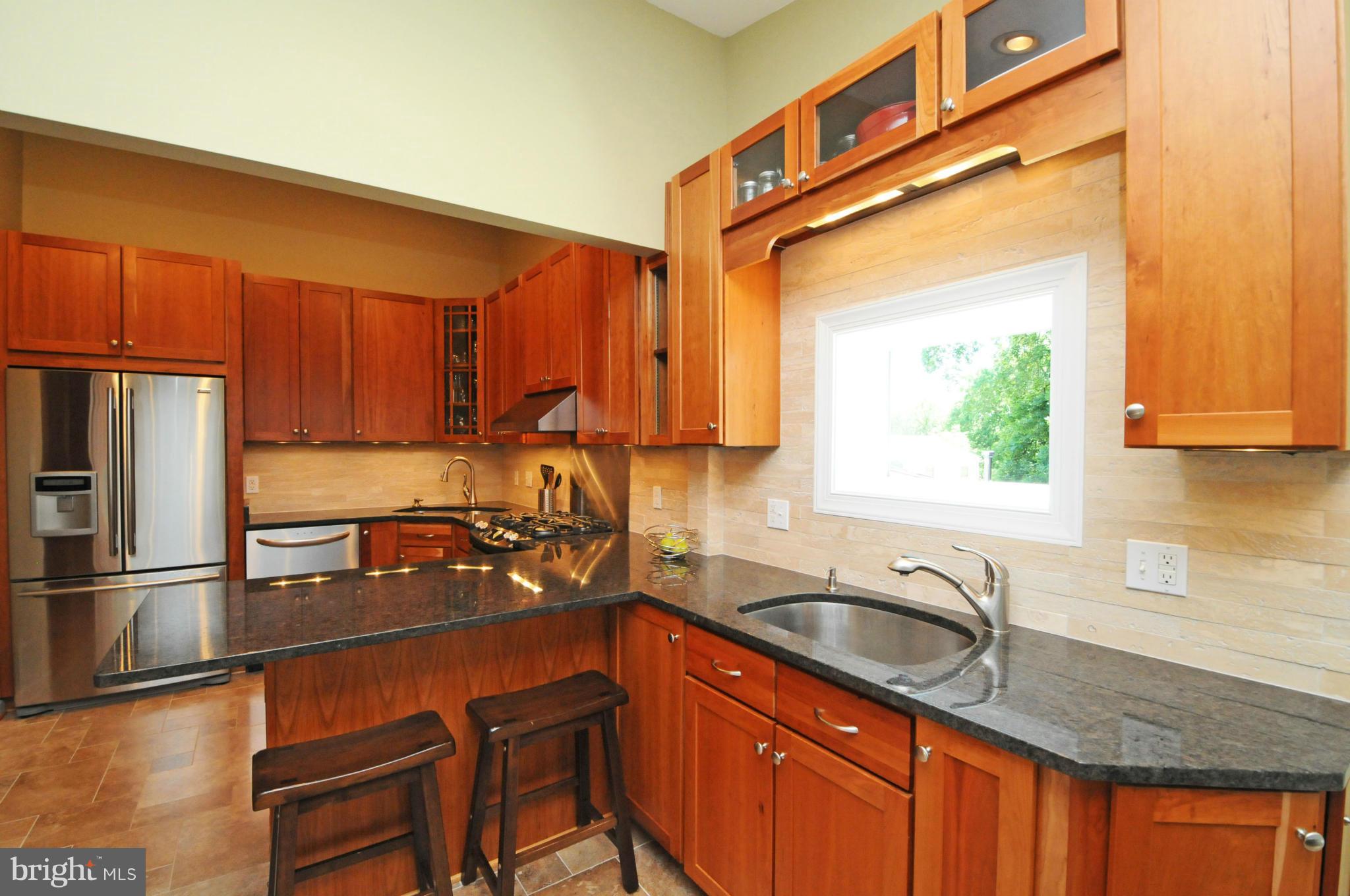 6313 Beryl Road Alexandria, VA 22312 - Photo 17 of 30 a kitchen with stainless steel appliances granite countertop a sink stove and refrigerator
