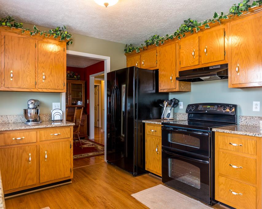 4212 Station Road Cunningham, TN 37052 - Photo 11 of 29 a kitchen with stainless steel appliances granite countertop a refrigerator a stove and a sink
