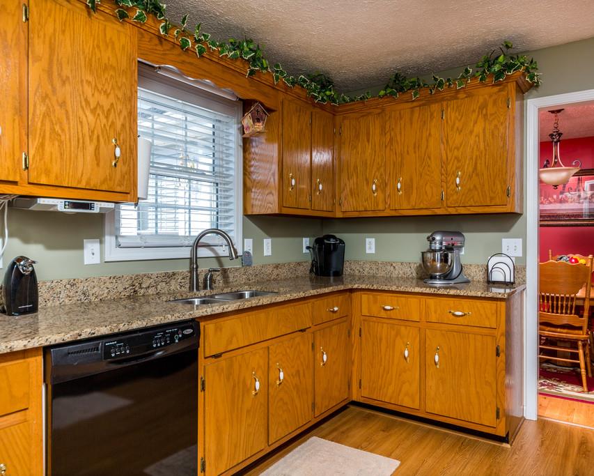4212 Station Road Cunningham, TN 37052 - Photo 12 of 29 a kitchen with stainless steel appliances granite countertop wooden cabinets a sink and dishwasher