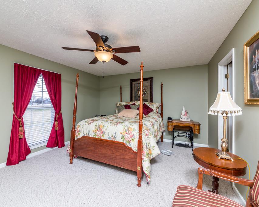 4212 Station Road Cunningham, TN 37052 - Photo 14 of 29 a bed room with a bed and a chandelier