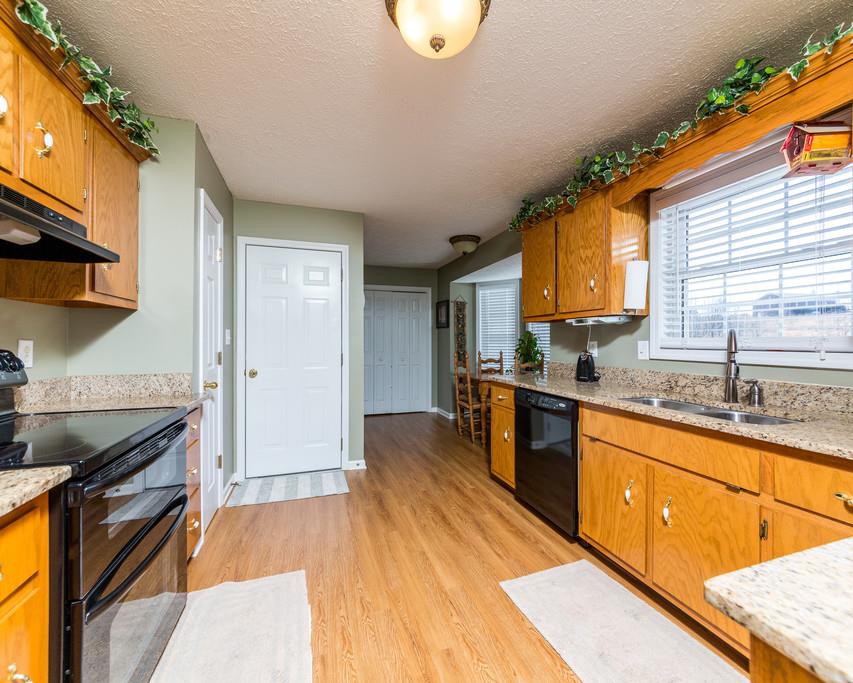 4212 Station Road Cunningham, TN 37052 - Photo 8 of 29 a kitchen with stainless steel appliances granite countertop a sink a stove cabinets counter space and a window