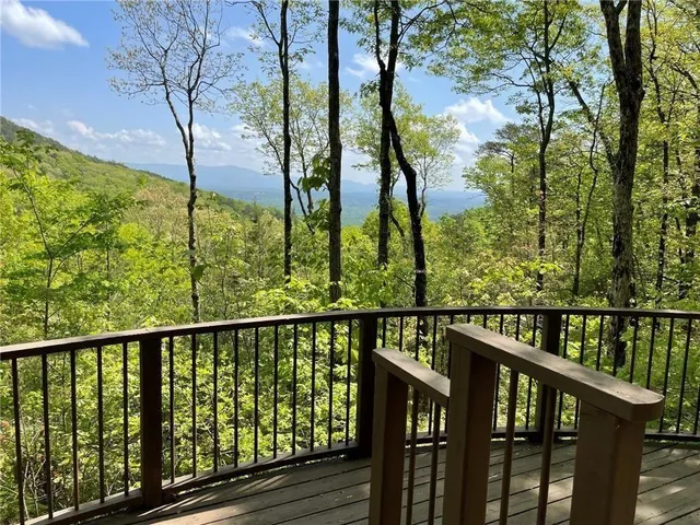a view of a balcony with wooden fence