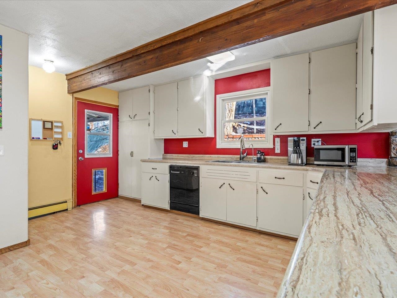 608 Bluff Street Delta, CO 81416 - Photo 16 of 42 a kitchen with stainless steel appliances granite countertop a sink dishwasher and cabinets with wooden floor