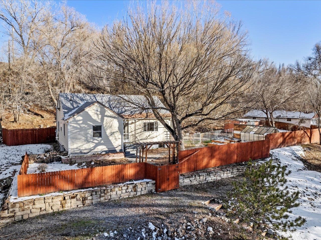 608 Bluff Street Delta, CO 81416 - Photo 2 of 42 a view of a yard with large trees