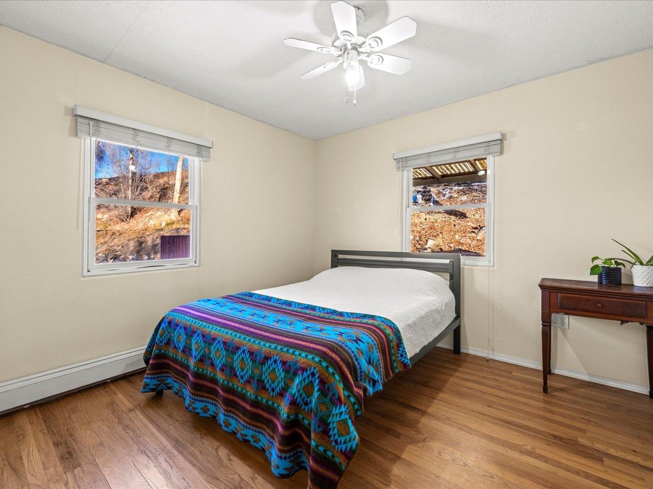608 Bluff Street Delta, CO 81416 - Photo 26 of 42 a bedroom with a bed and a painting on the wall