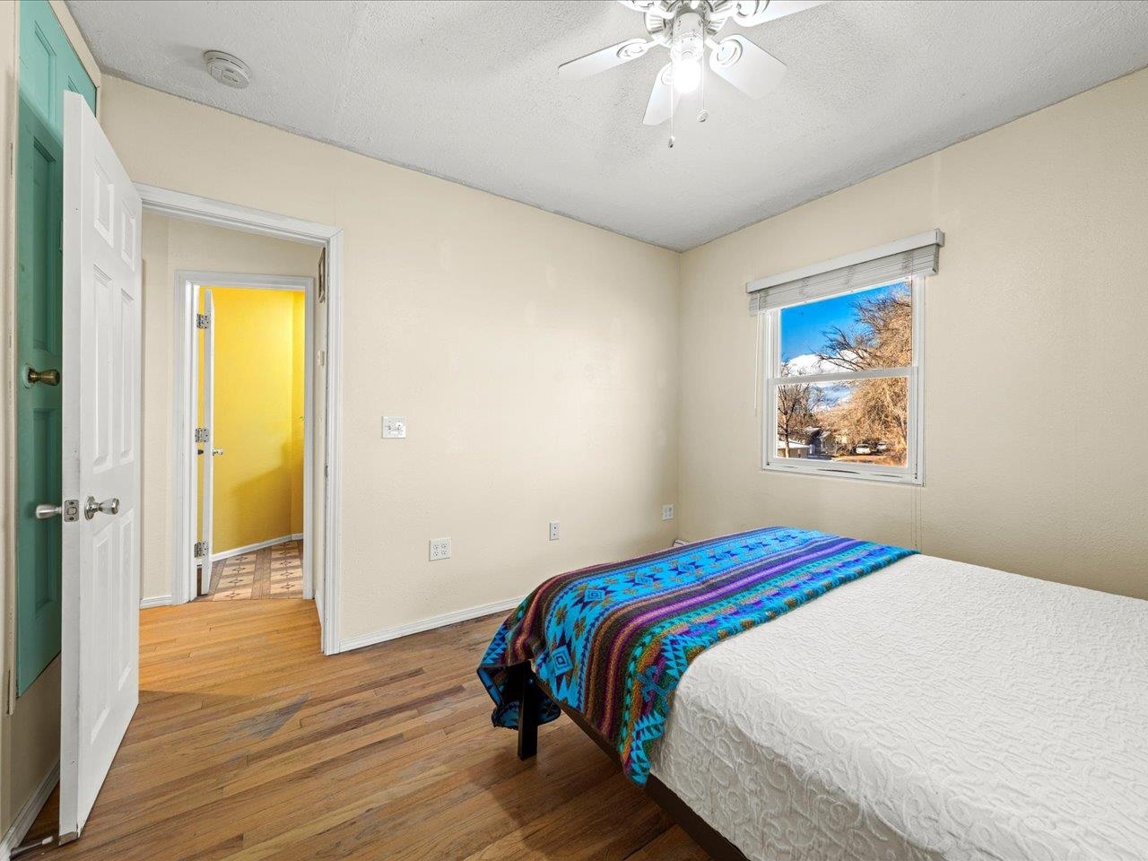 608 Bluff Street Delta, CO 81416 - Photo 27 of 42 a bedroom with a bed and a chandelier